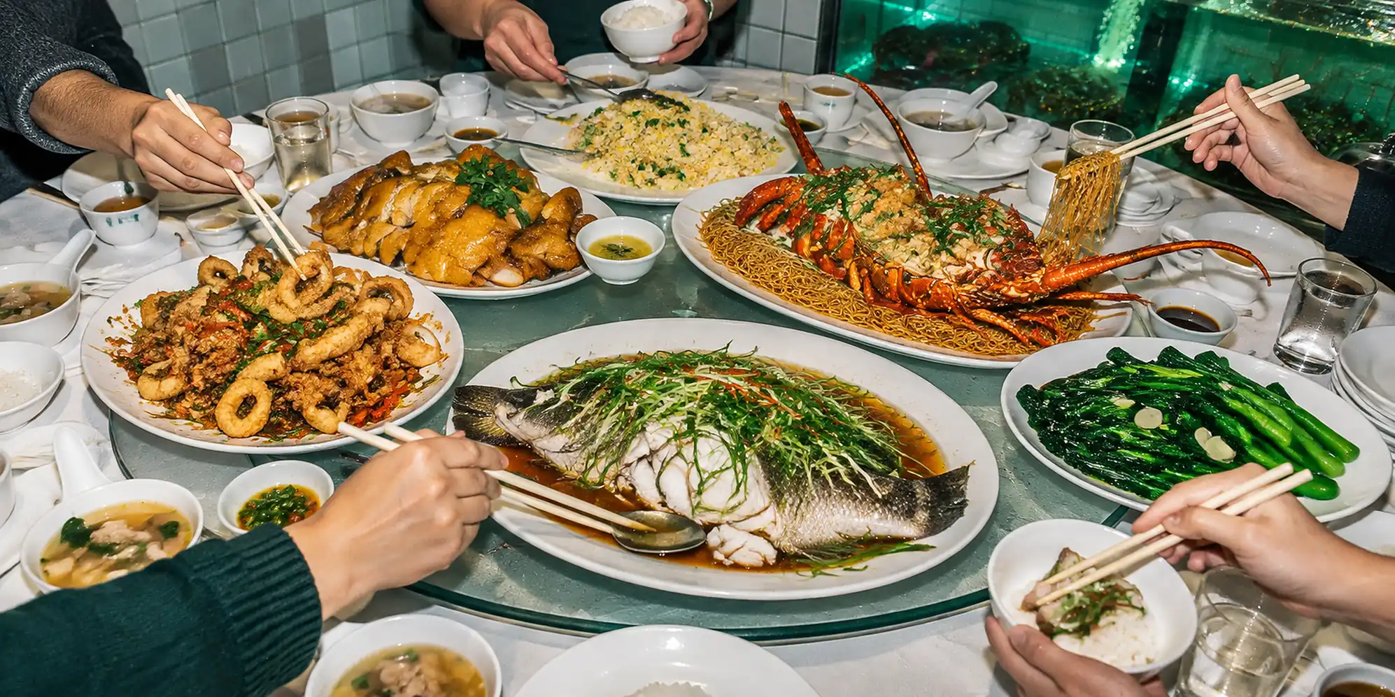 Overhead view of a ten-person round table covered in Cantonese banquet dishes.