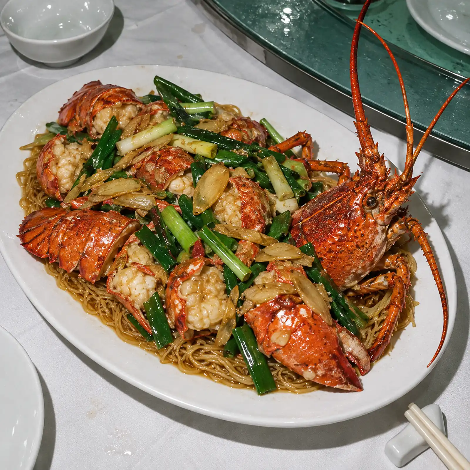 Ginger and spring onion lobster on braised e-fu noodles, shot from above with flash.